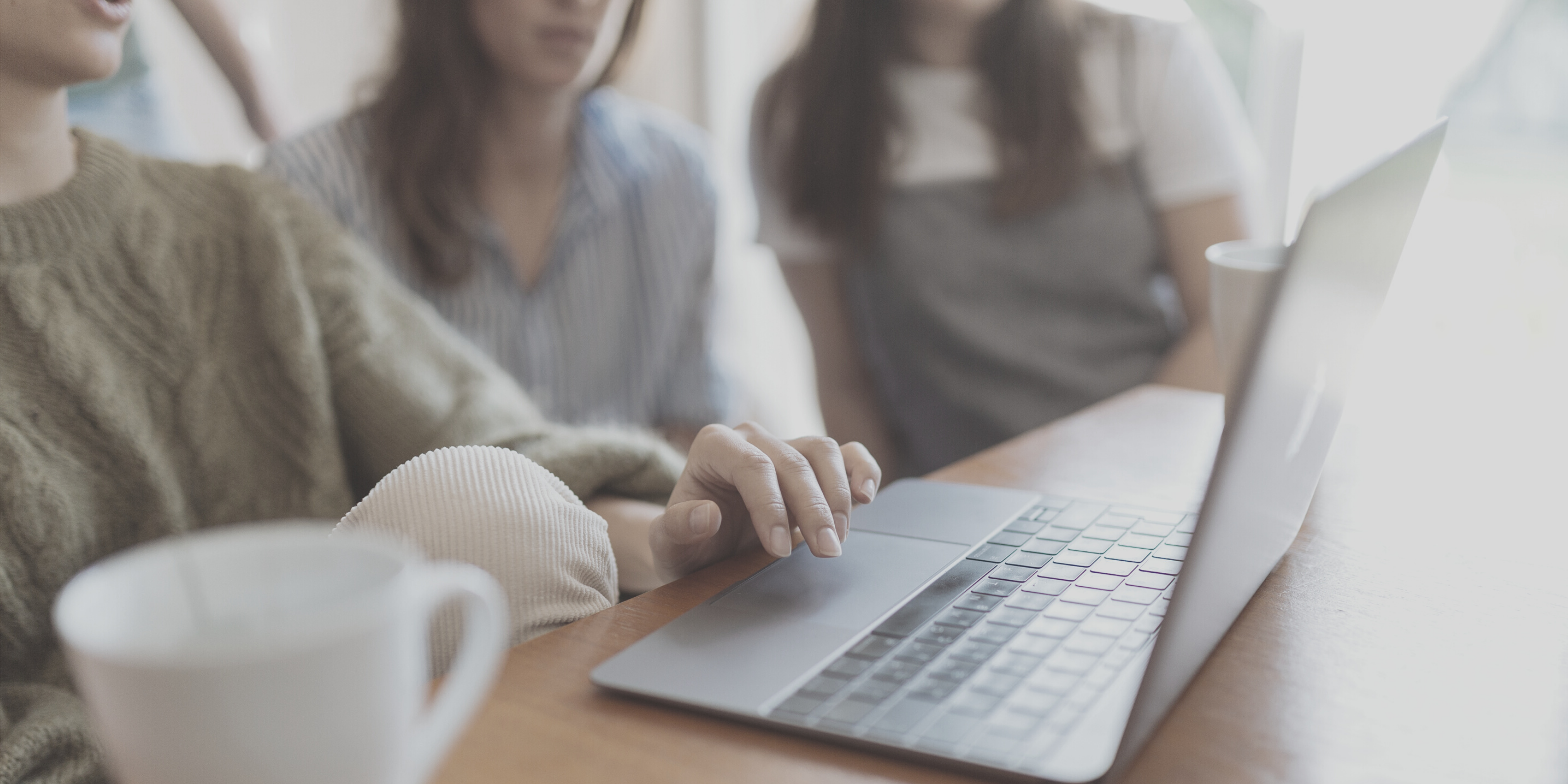 Three women collaborating on a marketing project